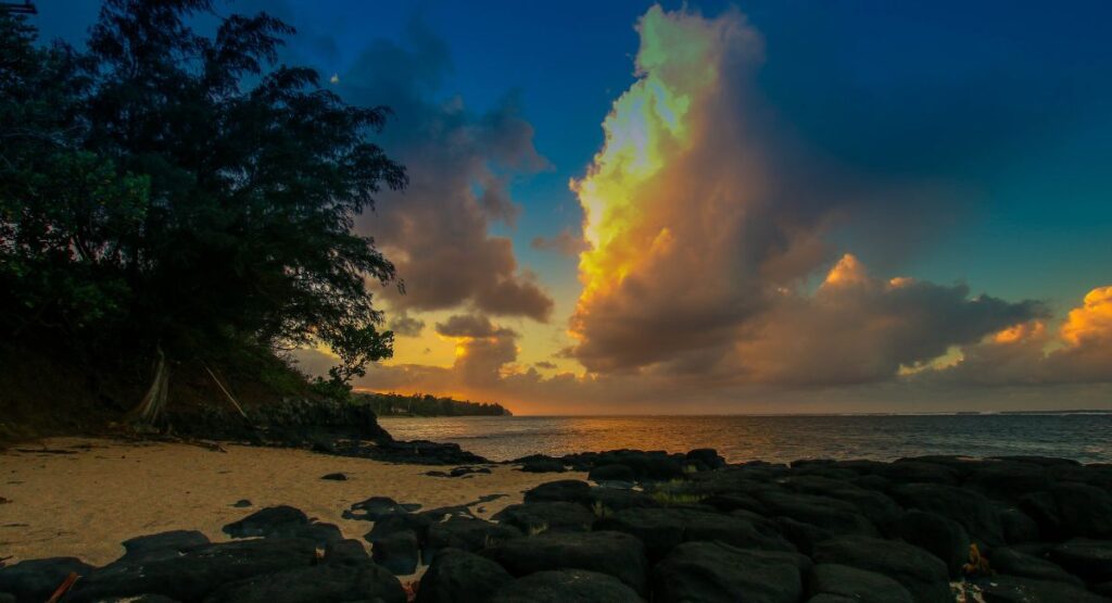 Sunset on a beach in Kauai with shadows and clouds
